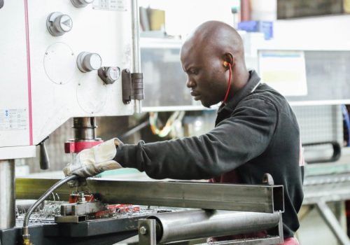 black-man-working-in-manufacturing-on-industrial-machine_t20_x60G3l