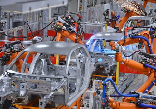 robots welding in an automobile factory